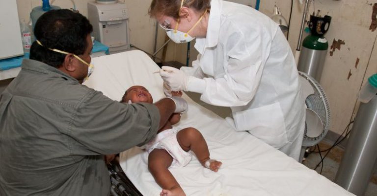 Baby Equipment - Baby Lying Down on Hospital Bed Getting a Check-up