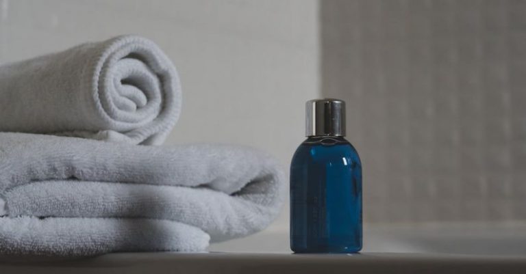 Toiletries - Blue Glass Bottle Beside White Towel