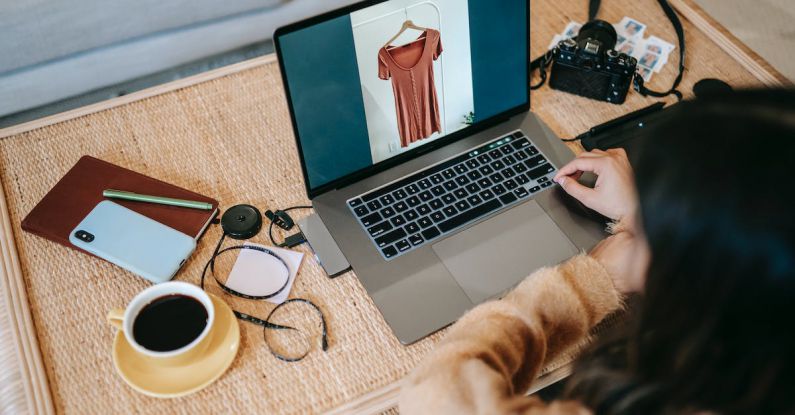 Portable Chargers - From above back view of crop anonymous female remote employee showing photography on netbook screen at table with hot drink