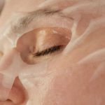 Anti-Aging - A Close-up Shot of a Woman with a Sheet Mask on Face