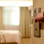 Hotels - Person Holding on Door Lever Inside Room