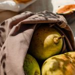 Eco-Friendly - Bags with Fresh Fruits and a Glass of Water Standing in Sunlight