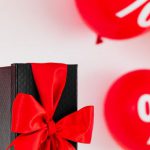Discounts - Present With Balloons On The Background